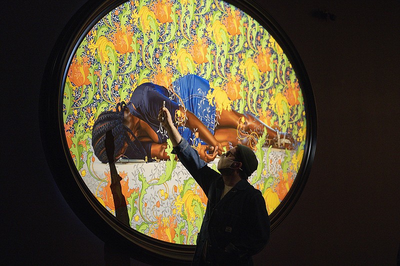 A man takes a picture March 24 of a painting by Kehinde Wiley titled "The Virgin Martyr St. Cecilia," at the de Young Museum in San Francisco. (AP/Godofredo A. Vásquez)