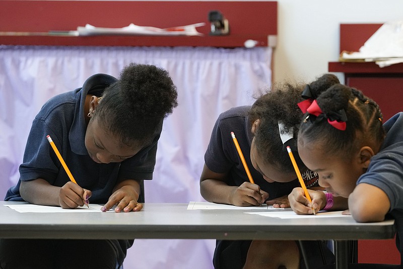 Second grade students write April 19 during class at Schaumburg Elementary, part of the ReNEW charter network, in New Orleans. (AP/Gerald Herbert)