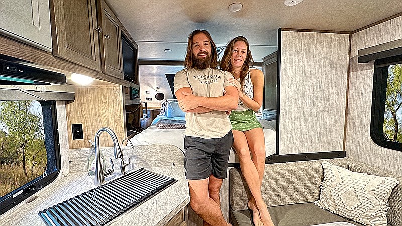 Arkansas couple Cody and Kellie Oden pose inside their new home, a 2017 Ford F350 fitted with a 2022 Palomino hard side HS2901 truck camper. The couple has ditched conventional living and now spends their time traveling the country, making videos to support their camping habit along the way. (Special the Democrat-Gazette/The Odens)