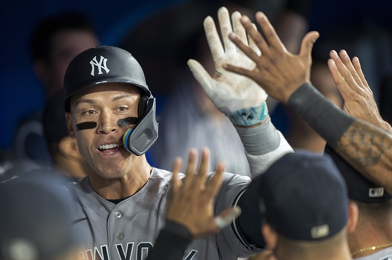 New York Yankees' Aaron Judge is congratulated by teammates after hitting his second home run of a baseball game, during eighth-inning action against the Toronto Blue Jays in Toronto, Ontario, Monday, May 15, 2023. (Frank Gunn/The Canadian Press via AP)