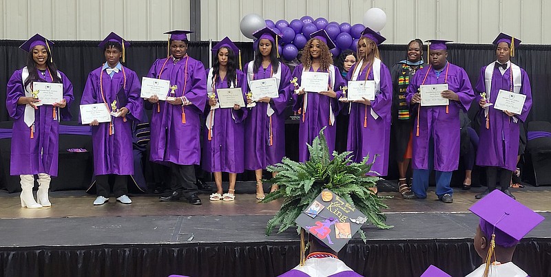 These nine students received Pioneer Awards from Friendship-Southeast for attending the campus from the time it was known as Southeast Arkansas Preparatory School to graduation: from left, Jasmine Davis, Marcus Antwine, BreShun Goodloe, Arereunti Goodwin, LaParis Harris, Bre'Naria Kearney, Latavia White, Braylon Williams and Kenneth Moore. (Pine Bluff Commercial/I.C. Murrell)