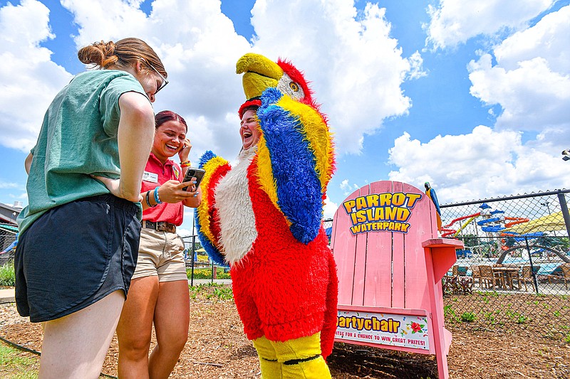 Sarah Thomas (from right), director of sales and marketing for Parrot Island Waterpark, visits Thursday with guest services supervisor Payton Rucker and friend Mary Ruple while filming a promotional video at the water park in Fort Smith. Visit nwaonline.com/photo for today's photo gallery.
(River Valley Democrat-Gazette/Hank Layton)