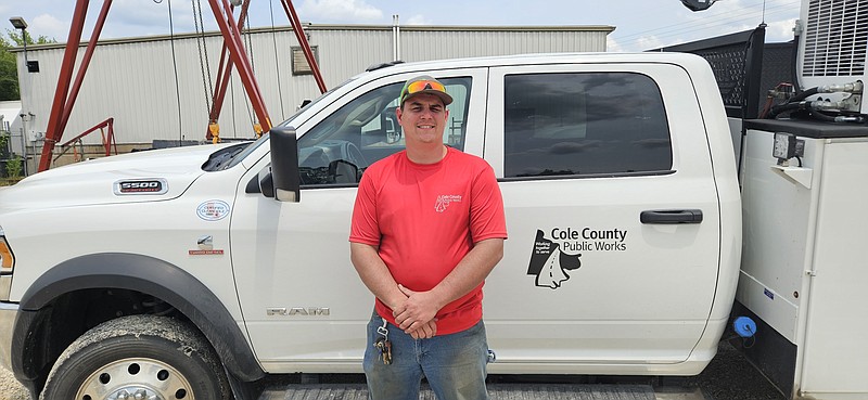 Alex Naughton/News Tribune photo: Tyler Clark, the newly promoted central maintenance supervisor for Cole County Public Works' new in-house maintenance program, stands in front of a public works truck Thursday afternoon, May 18, 2023.