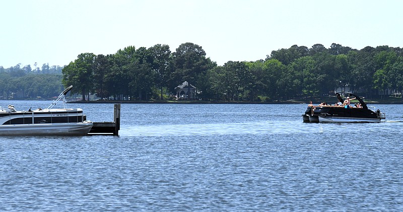 A boat approaches the dock at Futrell Marine on Lake Hamilton on Tuesday. - Photo by Lance Brownfield of The Sentinel-Record