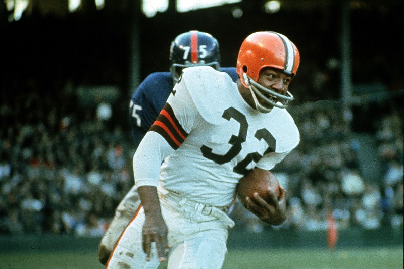 Jim Brown (32), running back for the Cleveland Browns, is shown in action against the New York Giants in Cleveland, Ohio, on Nov. 14, 1965. - File photo by The Associated Press