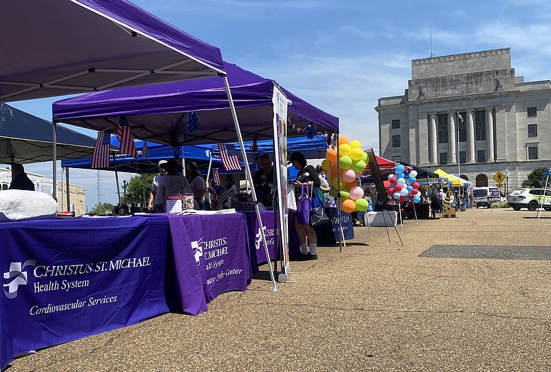 Vendors line State Line Avenue near the federal building for the inaugural Health on the Line health and wellness fair Friday, May 19, 2023, in downtown Texarkana. The fair featured approximately 30 vendors offering various services, including home care, medical supplies, assisted living and health insurance. (Staff photo by Sharda James)