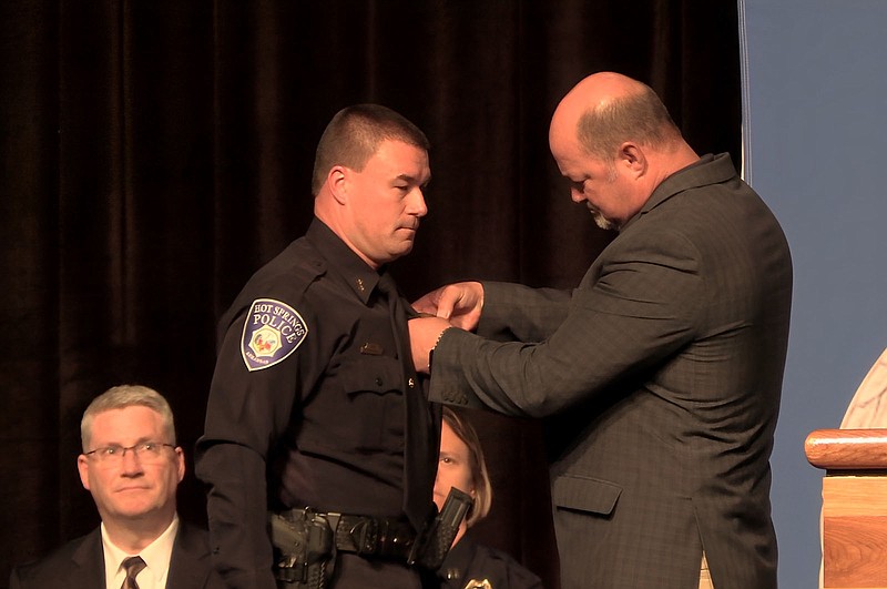 City Manager Bill Burrough, right, pins a badge on Hot Springs Police Chief Billy Hrvatin during the HSPD Badge Pinning Ceremony. – Photo by Courtney Edwards of The Sentinel-Record