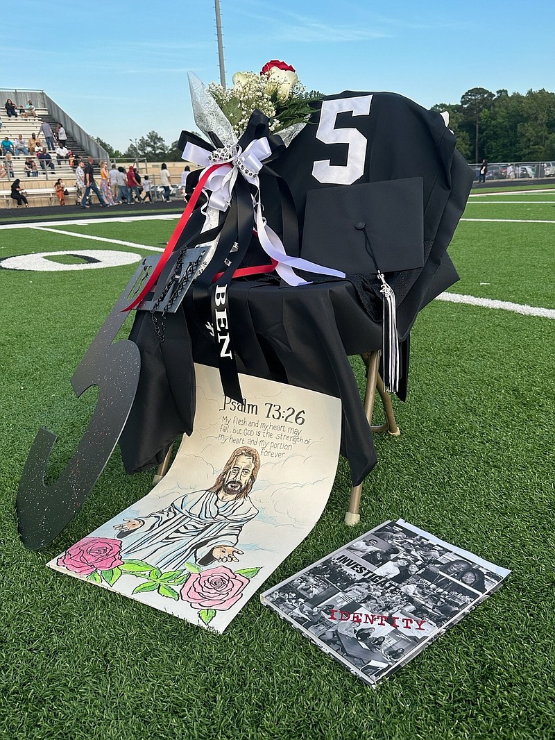 The graduation chair for White Hall High School senior Benjamin Redix is decorated with his football jersey, mortar board, flowers and drawing, among other things, on the Bulldog Stadium field at the school's graduation ceremony Friday night. Redix was shot to death Thursday night in North Little Rock. (Special to The Commercial/Deborah Horn)