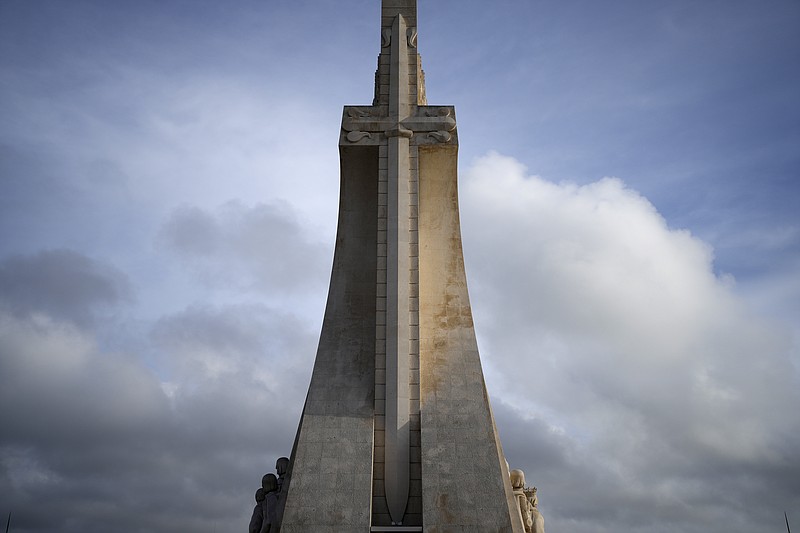 FILE - The sword of the Royal House of Avis on a stylised cross decorates the 56-meter high Monument to the Discoveries by the Tagus river in Lisbon, on March 30, 2023. The Vatican has recalled a postage stamp promoting this years World Youth Day in Portugal following complaints that it celebrated Portugals colonial empire and the nationalist dictatorship of Antonio Salazar. The stamp features Pope Francis leading a group of children up Lisbons Monument to the Discoveries. (AP Photo/Armando Franca, File)