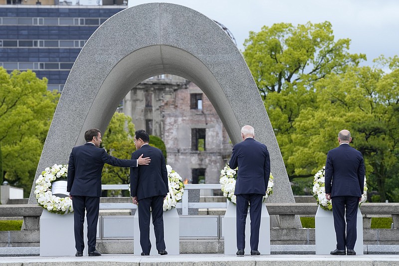 The Associated Press
President Emmanuel Macron, left, of France gestures to Prime Minister Fumio Kishida of Japan after laying a wreath at the Hiroshima Peace Memorial Park with U.S. President Joe Biden and Chancellor Olaf Scholz, right, of Germany in Hiroshima, Japan, on Friday during the G7 Summit.