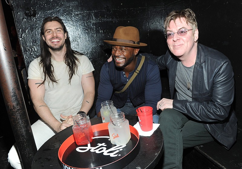 Stolis Professor of The Party Andrew W.K., left, Taye Diggs, center, and The Smith's Andy Rourke, Rock and Roll Hall of Fame nominee, celebrate 35 years of nightlife at The Pyramid Club on Avenue A as part of The Scene By Stoli Project, Tuesday, Oct. 28, 2014, in New York. 
(Photo by Diane Bondareff/Invision for Stoli Vodka/AP Images)