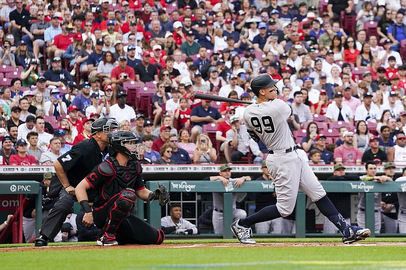 New York Yankees' Aaron Judge watches his solo home run against the Cincinnati Reds during the first inning of a baseball game in Cincinnati, Friday, May 19, 2023. (AP Photo/Jeff Dean)