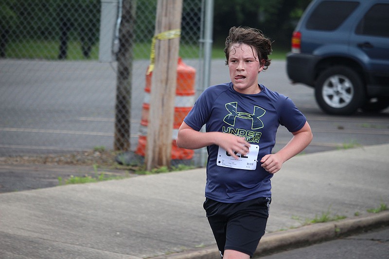 Mason Wolf, a 14-year-old runner from Lake Hamilton, wins the 27th Annual Norma Lampert Memorial Lupus Springers 5K Race and Walk to End Lupus Saturday at National Park College. - Photo by Krishnan Collins of The Sentinel-Record