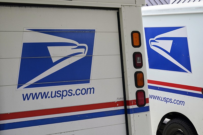 Mail delivery vehicles are parked outside a post office in Boys Town, Neb. in August 2020. 
(AP/Nati Harnik)