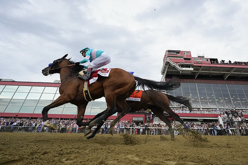 National Treasure, with jockey John Velazquez, edges out Blazing Sevens, with jockey Irad Ortiz Jr., to win the148th running of the Preakness Stakes horse race at Pimlico Race Course, Saturday, May 20, 2023, in Baltimore. (AP Photo/Julio Cortez)