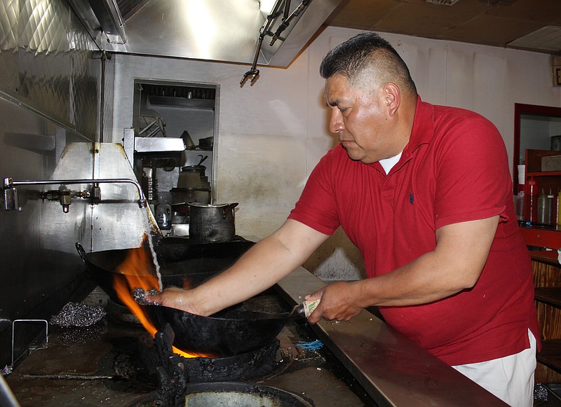 Jose Mendoza cleans a wok Sunday afternoon, May 21, 2023, at Lee's China in Texarkana, Texas. The restaurant, which closed for business less than a week ago, is reopening Friday, May 26 under the ownership of Mendoza and wife Patricia Moya. (Staff photo by Stevon Gamble)