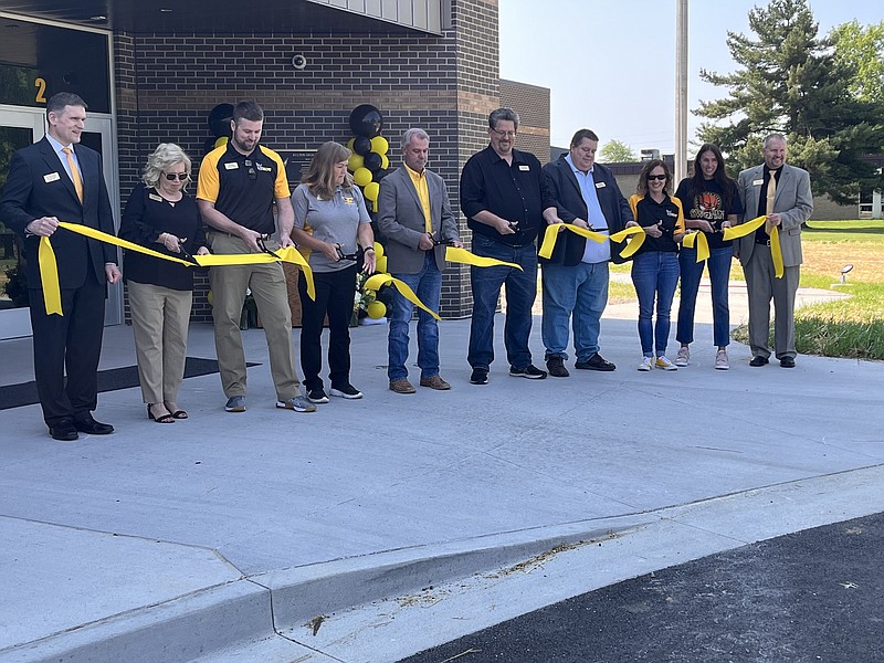 Morgan Slatten/Fulton Sun
The Fulton Public Schools Board of Education members and administration cut the ribbon at Saturday's open house event. The district is hoping to begin construction on the new kindergarten center soon.