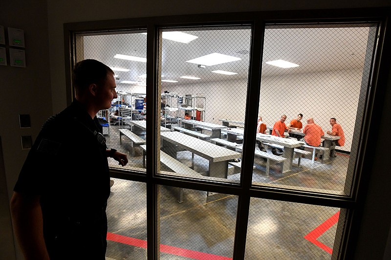 Deputy Chance Gregory looks in on prisoners May 2, 2017 at the Benton County Jail in Bentonville. (File Photo/NWA Democrat-Gazette/J.T. Wampler )