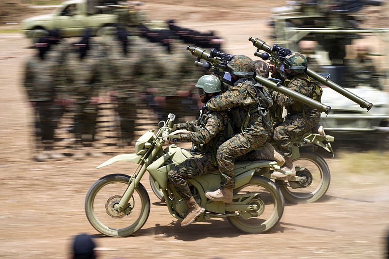 Fighters from the Lebanese militant group Hezbollah ride their motorcycles during a training exercise in Aaramta village in the Jezzine District, southern Lebanon, Sunday, May 21, 2023. The show of force came ahead of "Liberation Day," the annual celebration of the withdrawal of Israeli forces from south Lebanon on May 25, 2000, and in the wake of a recent escalation of the Israel-Palestine conflict in the Gaza Strip. (AP Photo/Hassan Ammar)