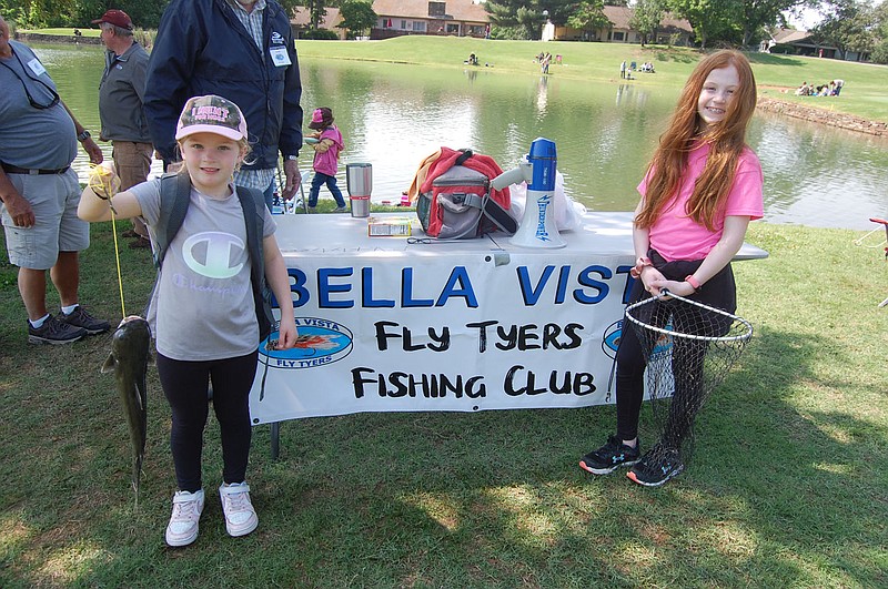 Bennett Horne/The Weekly Vista The Westover fishing team of sisters Katherine Westover, 6, (left) and Emma, 9, worked in tandem to land this catfish during the annual Property Owners Association Fishing Derby at Metfield Golf Course on Saturday, May 20. Katherine worked the rod and reel on this catch while Emma netted the fish.