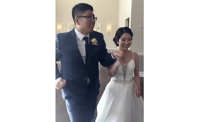 This photo provided by Young Min Kim shows the wedding of Kyu and Cindy Cho.  Among the eight people killed when a gunman opened fire at a Texas shopping mall on May 6, 2023, were Kyu and Cindy Cho and their 3-year-old son James. Their family's only survivor that day was their 6-year-old son, who was wounded.  (Young Min Kim via AP)