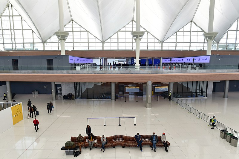 Travelers sit in part of the newly renovated areas on the 5th and 6th floor amid Phase 1 of terminal improvements on the $770 million Great Hall renovation project at Denver International Airport on Oct. 27, 2021, in Denver. The renovations created a more modern check-in experience and added capacity in the terminal as well as improving operational efficiency. (Helen H. Richardson/The Denver Post/TNS)