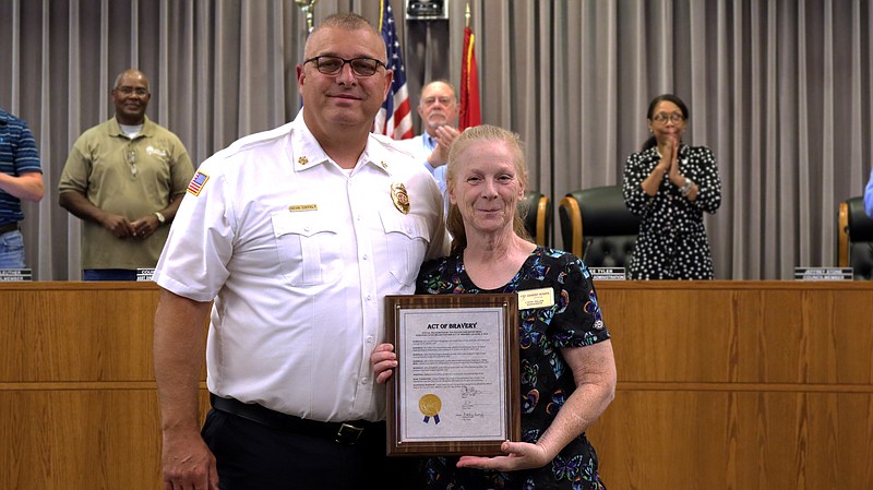 Fulton Fire Department Chief Kevin Coffelt (left) and Kathy Miller, facility supervisor for Ashbury Heights (right), pose for a photo Tuesday, May 23, 2023, at the Fulton City Council meeting. Coffelt recognized Miller for assisting during a fire at Ashbury Heights in April. (Photo courtesy City of Fulton)