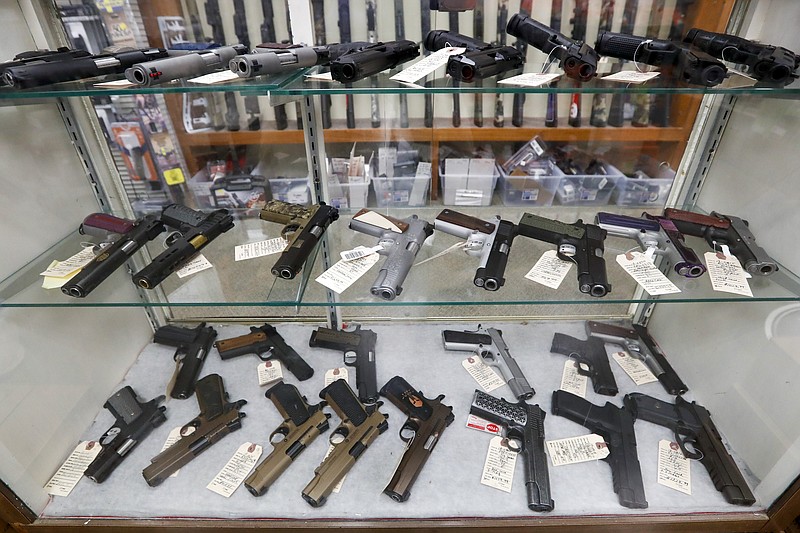 FILE - Semi-automatic handguns are displayed at shop in New Castle, Pa., March 25, 2020. A federal appeals court has dealt a legal setback to the Biden administration on guns in a lawsuit challenging tighter regulations on stabilizing braces, an accessory used in several mass shootings. The Fifth Circuit Court of Appeals temporarily blocked an administration rule from going into effect for the gun owners and groups who filed the lawsuit. The order came shortly before a deadline for people to register them and pay a fee, or remove the stabilizing braces from their weapons.  (AP Photo/Keith Srakocic, File)