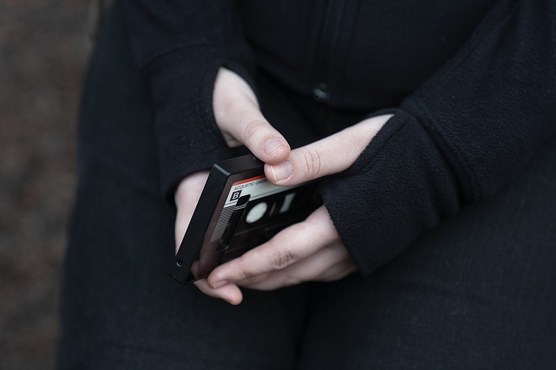 File - A teenager holds her phone as she sits for a portrait near her home in Illinois, on Friday, March 24, 2023. The U.S. Surgeon General is warning there is not enough evidence to show that social media is safe for young people &#x2014; and is calling on tech companies, parents and caregivers to take &quot;immediate action to protect kids now.&quot; (AP Photo Erin Hooley, File)