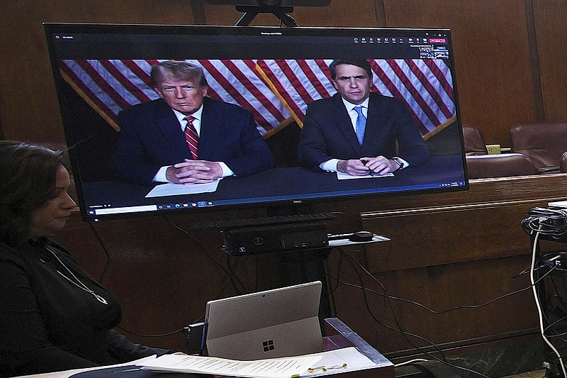 Former president Donald Trump, left on screen, and his attorney, Todd Blanche, right on screen, appear by video before a hearing begins in Manhattan criminal court, in New York, Tuesday, May 23, 2023. Trump made a video appearance Tuesday in his New York criminal case, with the judge setting a trial date for late March of next year. (AP Photo/Curtis Means via Pool)