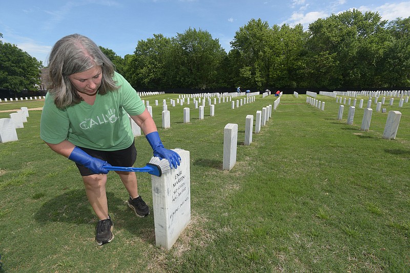 IN HONOR OF VETERANS
Sarah Cox cleans headstones on Saturday May 13 2023 at the Fayetteville National Cemetery. Some 50 volunteers gathered to wash headstones in preparation for Memorial Day, said Jannie (cq) Layne, coordinator. The markers have been cleaned twice each year since 2017, she said. Volunteer include veterans and their families and anyone willing to pitch in and help. Go to nwaonline.com/photos for today's photo gallery.
(NWA Democrat-Gazette/Flip Putthoff)