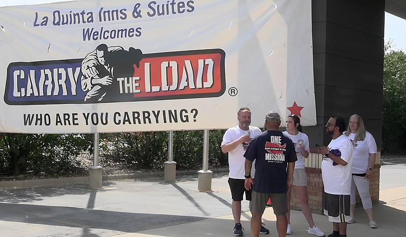 A group of La Quinta's participants in Carry the Load stand in front of the hotel, where the relay in Hot Springs ended. – Photo by Courtney Edwards of The Sentinel-Record