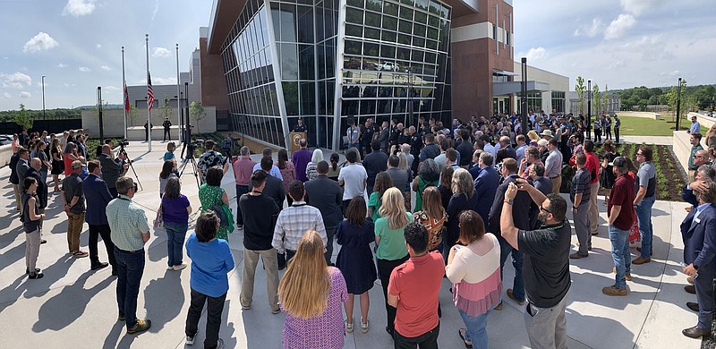 A large crowd listens Wednesday, May 24, 2023, as Mike Reynolds, chief of the Fayetteville Police Department, speaks during a dedication ceremony for the Fayetteville Police Departmentâ€™s new headquarters building in Fayetteville. Voters approved a bond measure in April 2019 to pay for a new police headquarters building. Construction began on the approximately 82,500-square-foot secured facility in February 2021, according to a city news release. It is fully ADA accessible, includes several areas capable of hosting public meetings and programming and offers increased space, safety and security for members of the public, officers and staff. The building opened to the public May 1. Visit nwaonline.com/photo for today's photo gallery. 
(NWA Democrat-Gazette/Andy Shupe)