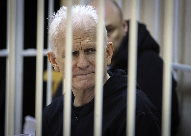 FILE - Ales Bialiatski, the head of Belarusian Vyasna rights group, sits in a defendants' cage during a court session in Minsk, Belarus, on  Jan. 5, 2023. Nobel Peace Prize laureate Ales Bialiatski has been transferred to a notoriously brutal prison in Belarus and hasn't been heard from in a month, his wife said Wednesday, May 24, 2023. (Vitaly Pivovarchyk/BelTA Pool Photo via AP, File)