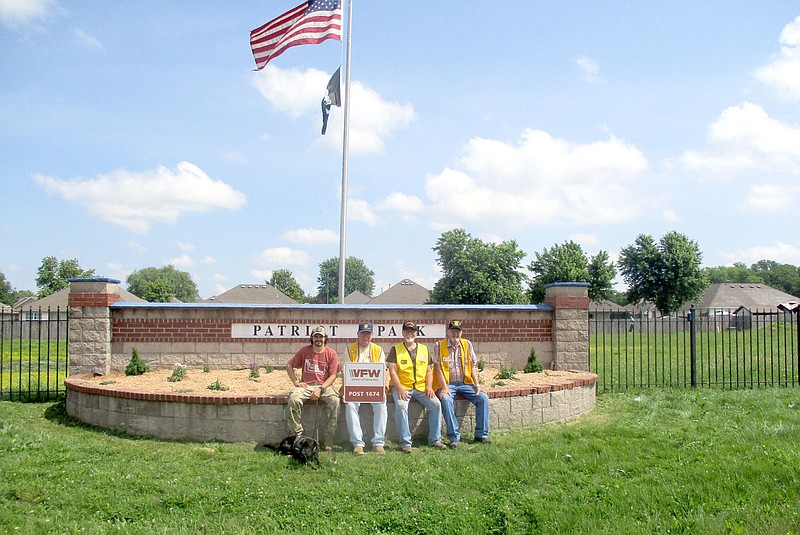 Marc Hayot/Herald-Leader VFW Post 1674 members Jordan Farmer (left) Frank Lee, Ken Leach and Don Welch pose in front of the flower bed at Patriot Park after planting new flowers. The VFW took over maintenance of the flower bed and flags at Patriot Park from the city, said Leach. The city previously maintained the flower bed and flags and will still continue to mow the grass at Patriot Park, Leach said.