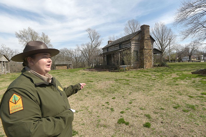 Mattison Griffin, interpreter at Prairie Grove Battlefield State Park, leads a tour of historic Civil War era homes that were moved from various Northwest Arkansas locations to what is now the state park.
(NWA Democrat-Gazette/Flip Putthoff)