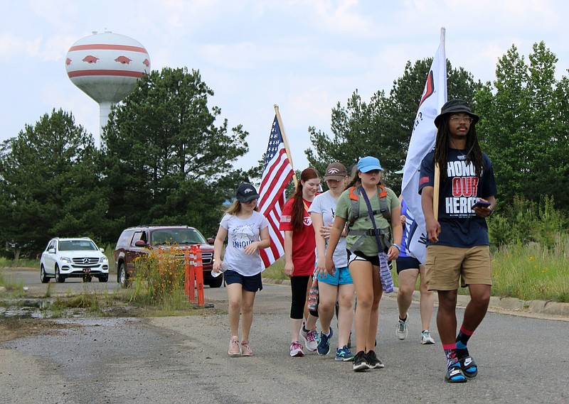 Zaki Muhammed leads public participants in the second Texarkana leg of Carry the Load on Thursday afternoon, May 25, 2023, in Texarkana, Ark. Muhammed and his seven other team members are part of the relay's New England route, which left Burlington, Vt., on May 3. They are joining four other route teams across the nation on Memorial Day in Dallas. (Staff photo by Stevon Gamble)