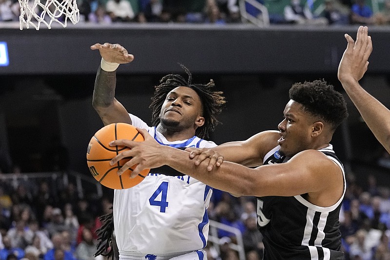 Providence forward Ed Croswell (5) and Kentucky forward Daimion Collins (4) reach for a rebound during the second half of a first-round of the NCAA Tournament Friday, March 17, 2023, in Greensboro, N.C. (AP Photo/John Bazemore)