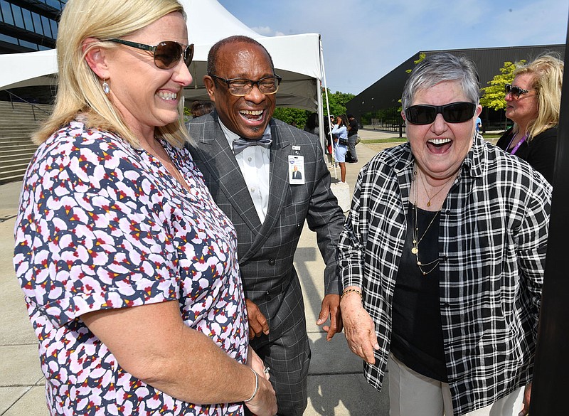 John L Colbert (center), superintendent of Fayetteville Public Schools, shares a laugh Thursday, May 25, 2023, with Faye Jones (right), a retired longtime educator, and Jones daughter, Ashley Jennings, during a retirement reception for Colbert at Fayetteville High School. Colbert retires after 47 years of service in public education. Visit nwaonline.com/photo for today's photo gallery. 
(NWA Democrat-Gazette/Andy Shupe)