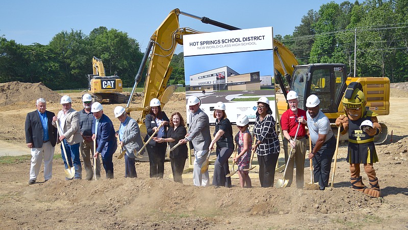 Local leaders join Hot Springs School Board members and the Trojan mascot to break ground on the new high school Wednesday morning at 821 Emory St. - Photo by Donald Cross of The Sentinel-Record