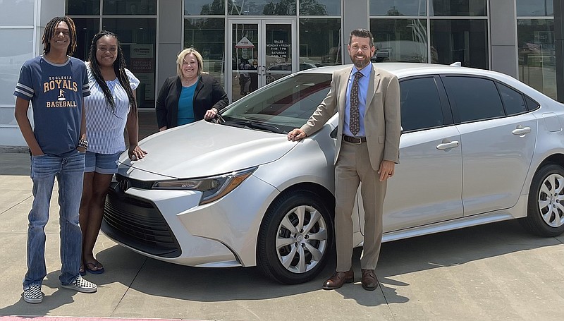 Liberty-Eylau High School graduating senior Kalen Redmond, from left, Redmond's mother, Terece Gooden, Robbins Toyota owner Susan Robbins, and general manager Charles Pankey pose for a photo with Redmond's new 2023 Toyota Corolla on Friday, May 26, 2023, at the dealership in Texarkana, Texas. Redmond won the car in a drawing for local students with perfect school attendance. (Photo courtesy of Robbins Toyota)