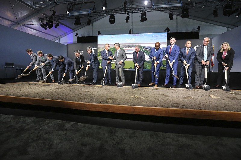 FILE - Chung Eui-sun, center left, executive chairman of Hyundai Motor Group, shakes hands with Georgia Gob. Brian Kemp as dignitaries join in for the official groundbreaking ing for the Hyundai Meta Plant, Oct. 25, 2022, in Ellabell, Ga. Hyundai and LG Energy Systems say they will build a $4.3 billion electric battery plant in Georgia. The factory would be on the site of the new electric vehicle assembly plant that Hyundai Motor Group is building near Savannah. The companies will split the investment, starting production as early as late 2025. (Richard Burkhart/Savannah Morning News via AP, File)