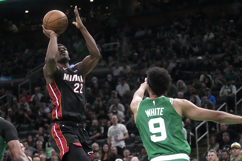 Miami Heat forward Jimmy Butler, left, shoots as Boston Celtics guard Derrick White defends Thursday in Boston. - Photo by Charles Krupa of The Associated Press