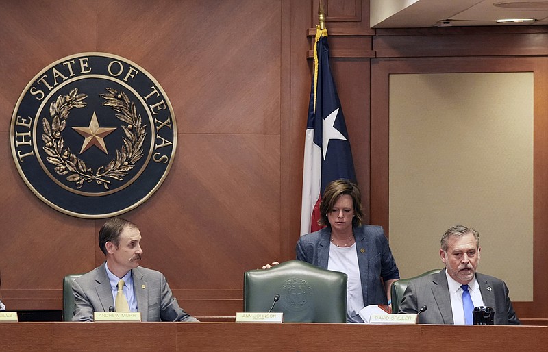 Rep. Andrew Murr, R - Junction, Chair of the House General Investigating Committee, left to right, Rep. Ann Johnson, D - Houston, and Rep. David Spiller, R - Jacksboro, get ready to leave after the meeting where it was recommended that the committee adopt the articles of impeachment against Attorney General Ken Paxton at the Capitol in Austin, Texas, on Thursday May 25, 2023.  (Jay Janner/Austin American-Statesman via AP)