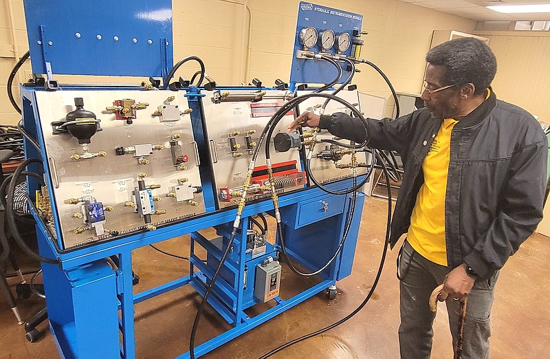 O.C. Duffy Jr., an instructor of civil construction engineering and manufacturing at UAPB, describes the components of a fluid power system inside a laboratory in the Rust Technology Hall of the campus Friday. (Pine Bluff Commercial/I.C. Murrell)