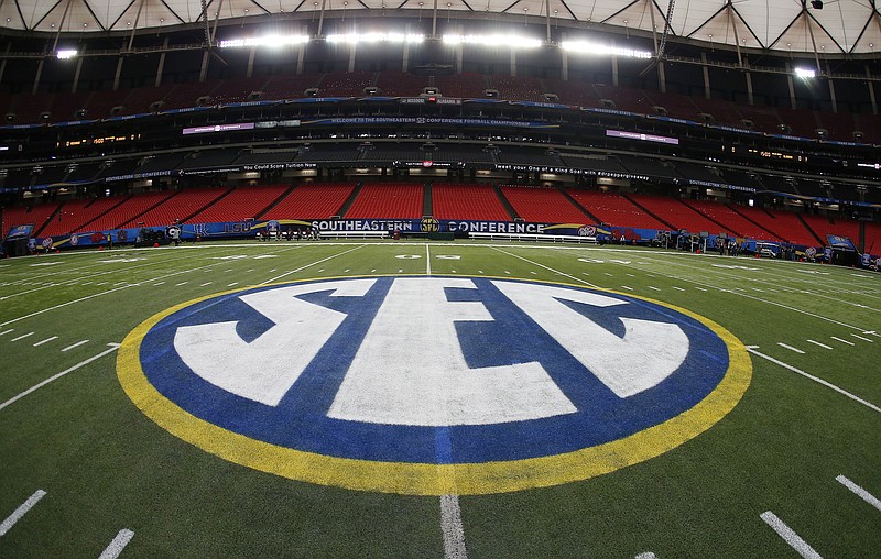 FILE - The SEC logo is displayed on the field ahead of the Southeastern Conference championship football game between Alabama and Missouri on Dec. 5, 2014, in Atlanta. Southeastern Conference leaders will continue debating what to do with their football schedule when they meet in the Florida Panhandle starting Tuesday, May 30, 2023. (AP Photo/John Bazemore, File)