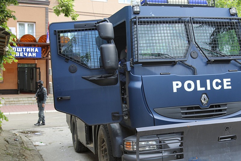 Kosovo police officers guard a municipal building after yesterday's violent clashes between police and ethnic Serbs, in the town of Zvecan, northern Kosovo, Saturday, May 27, 2023. Serbia on Saturday condemned NATO-led peacekeepers stationed in neighboring Kosovo for their alleged failure to stop "brutal actions" by Kosovo police against ethnic Serbs and said that its armed forces stationed near the border will remain on the highest state of alert until further notice. (AP Photo/Dejan Simicevic)