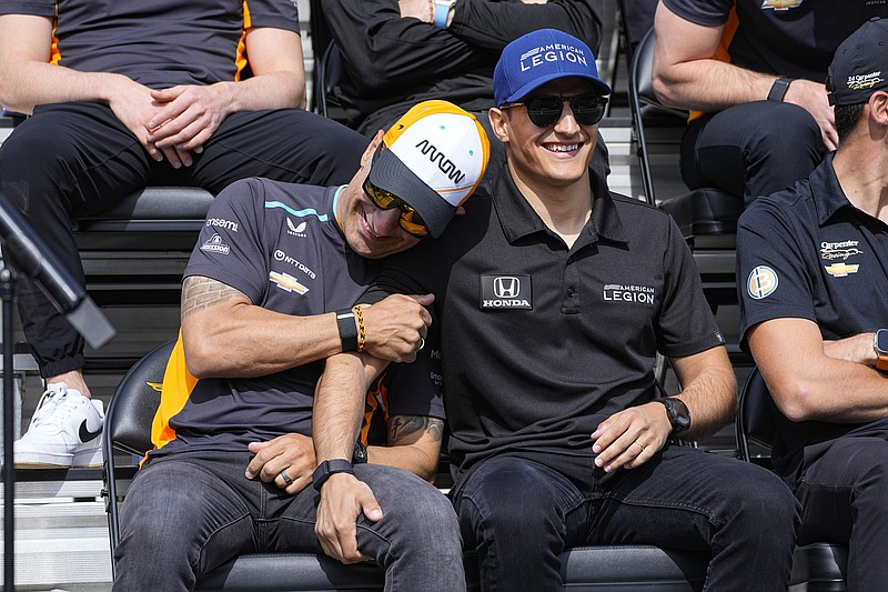 Tony Kanaan, of Brazil, left, jokes with Alex Palou, of Spain, during the drivers meeting for the Indianapolis 500 auto race at Indianapolis Motor Speedway in Indianapolis, Saturday, May 27, 2023. (AP Photo/Darron Cummings)