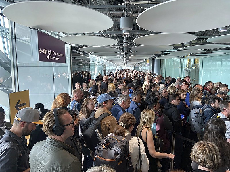 People queue at arrivals at Heathrow airport in London, Saturday, May 27, 2023. The British government is working to fix a technical problem that caused electronic border gates at airports around the country to stop working, leading to hourslong waits for travelers entering the U.K. at the start of a busy holiday weekend. (Ivan Coninx via AP)