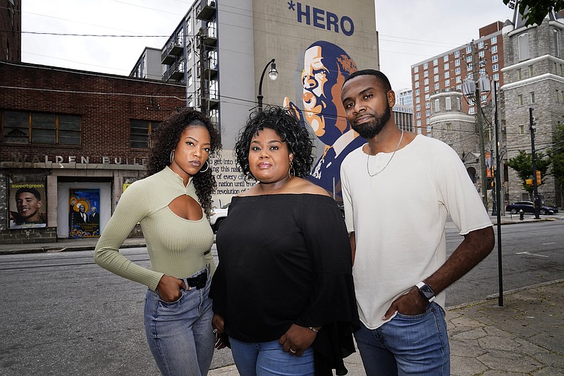 FILE - D'Zhane Parker, left, Cicley Gay, center, and Shalomyah Bowers pose for a portrait on May 13, 2022, in Atlanta. Black Lives Matter Global Network Foundation Inc., a national Black Lives Matter nonprofit, whose philanthropic fortunes grew almost overnight during historic racial justice protests three years ago, raised just over $9 million in its last fiscal year, new IRS tax filings show. Cicley Gay, board chair for the foundation, said the belt tightening was part of an effort to demonstrate that its stewards “have been responsible, proactive decision-makers of the peoples donations.” (AP Photo/Brynn Anderson, File)